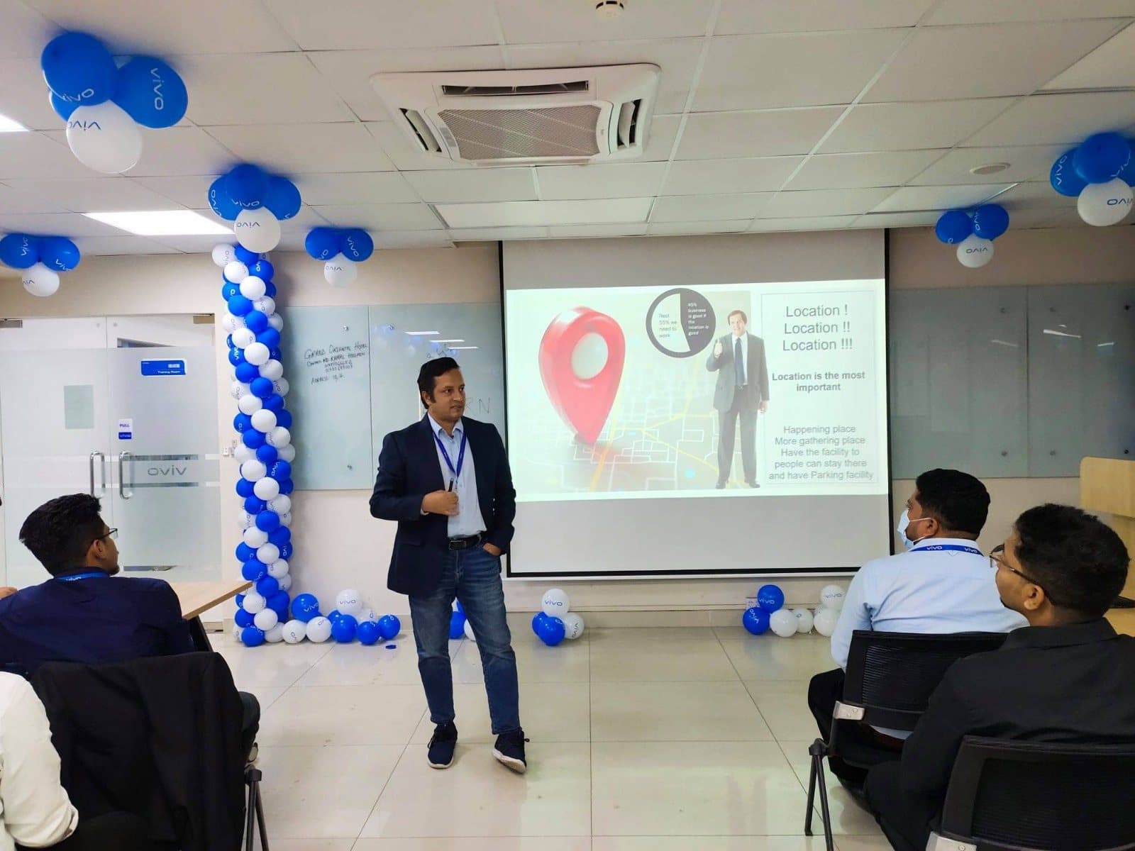 Presenting to colleagues in a balloon-decorated room